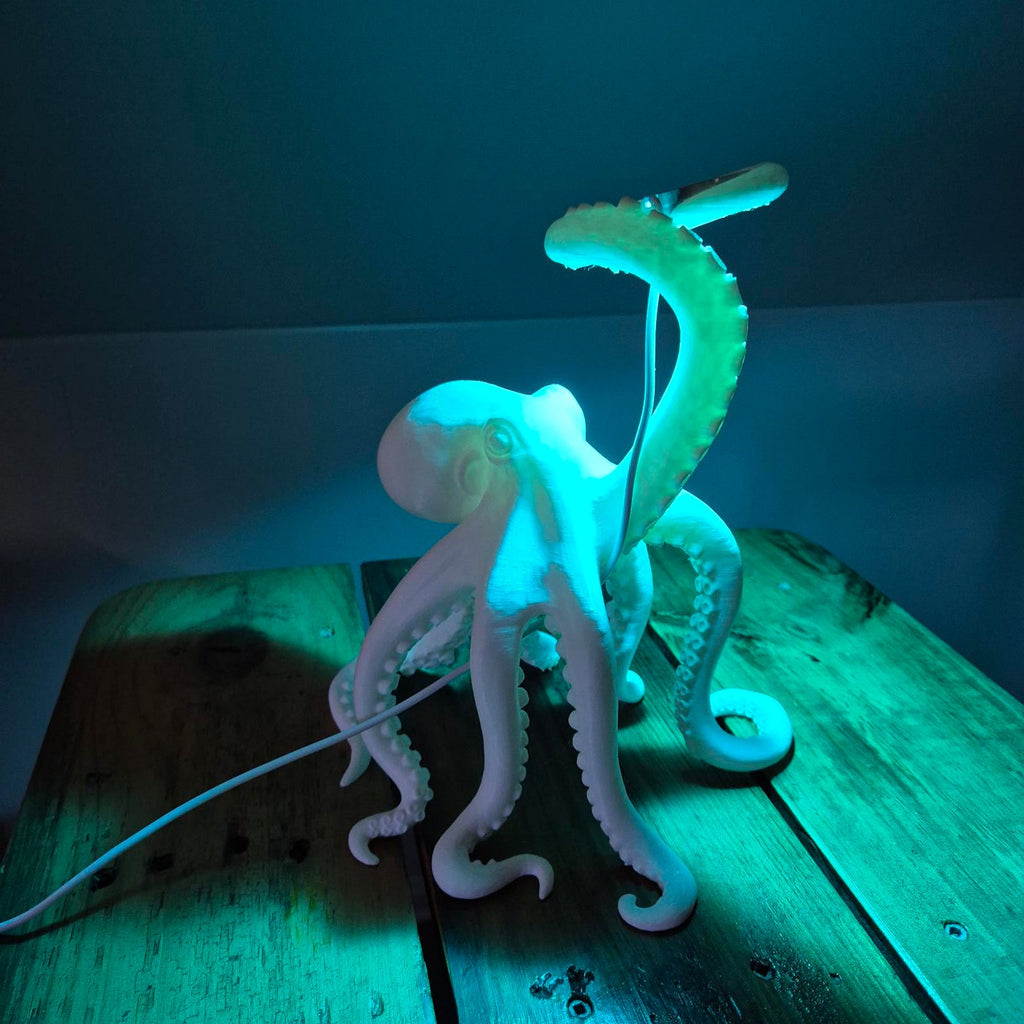 Glowing octopus-shaped light fixture on a wooden surface